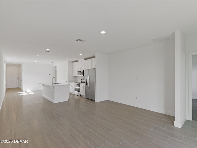 unfurnished living room featuring sink