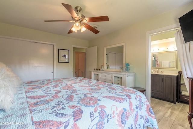 bedroom with ceiling fan, ensuite bath, a closet, and light wood-type flooring