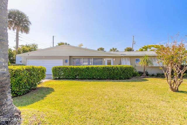 ranch-style home with a garage and a front lawn