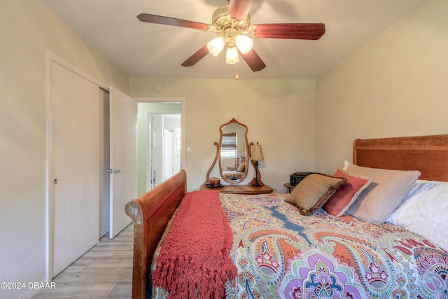 bedroom with light hardwood / wood-style floors and ceiling fan