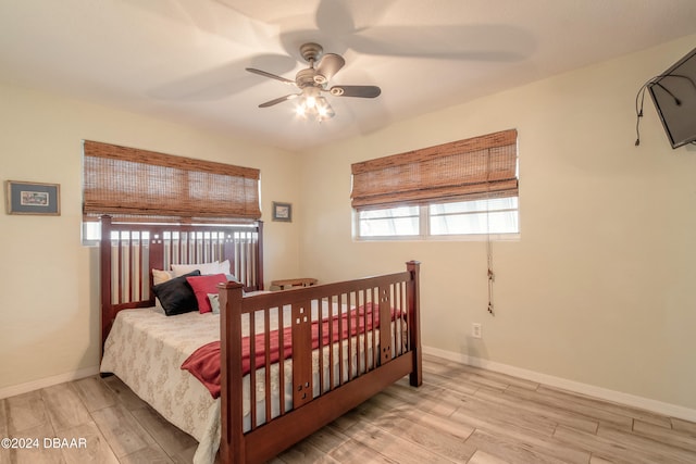 bedroom with ceiling fan and light wood-type flooring