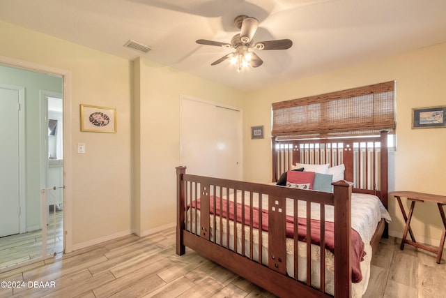 bedroom with light wood-type flooring and ceiling fan