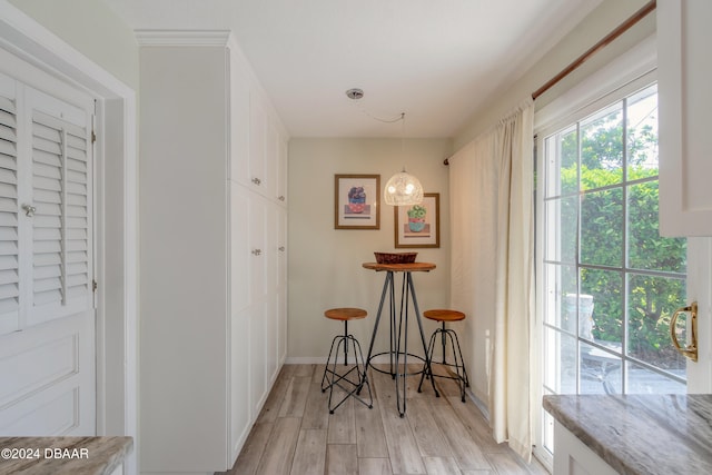 corridor with light hardwood / wood-style flooring