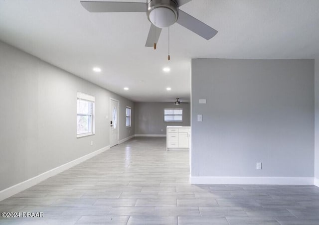 unfurnished room with ceiling fan and light wood-type flooring