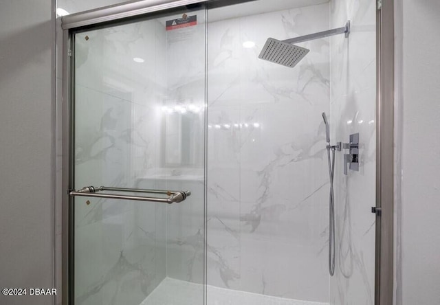 bathroom with a shower with shower door