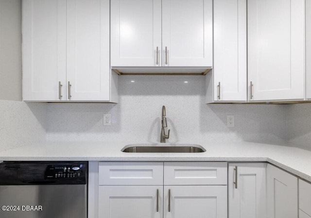 kitchen with decorative backsplash, sink, white cabinetry, and dishwasher