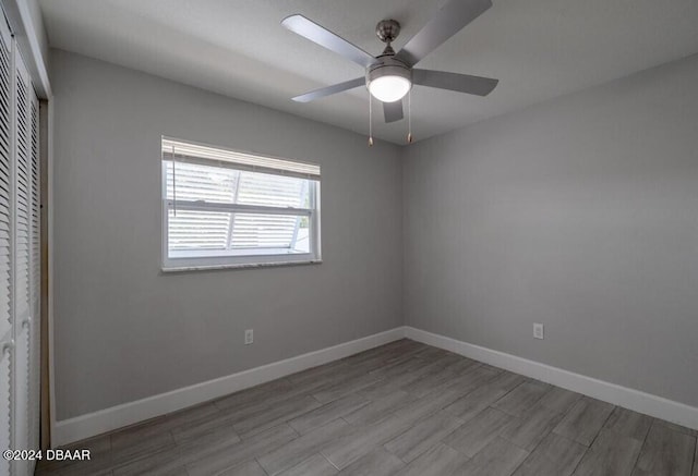 empty room with ceiling fan and light hardwood / wood-style floors