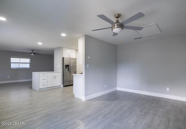 unfurnished living room featuring ceiling fan and light hardwood / wood-style floors