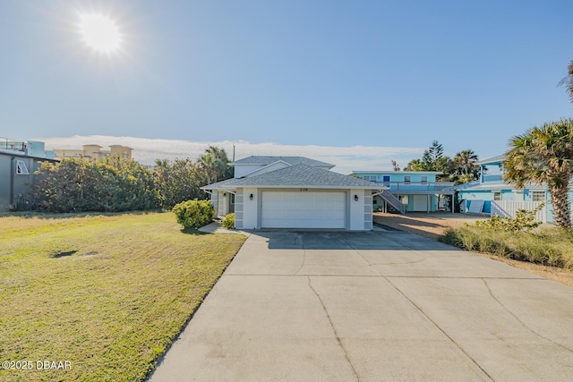 view of front of home featuring a garage and a front yard