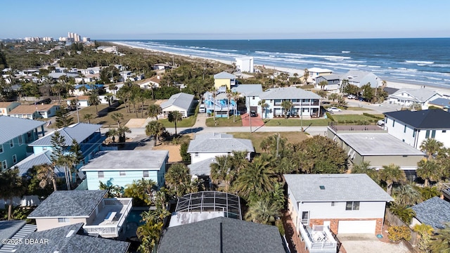 birds eye view of property with a water view and a view of the beach