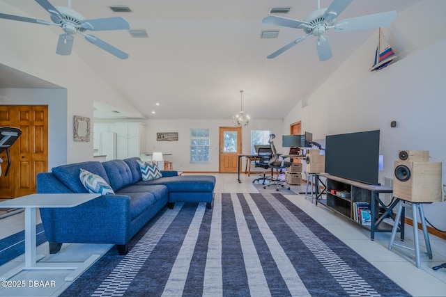 tiled living room with ceiling fan with notable chandelier and high vaulted ceiling