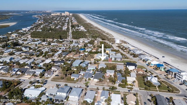 bird's eye view featuring a water view and a beach view