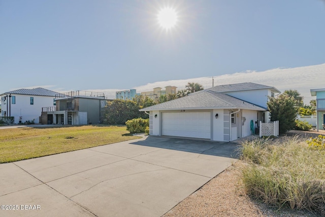 view of front of property with a garage and a front lawn