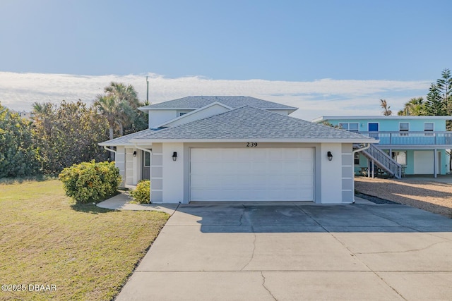 view of front of home featuring a garage and a front yard