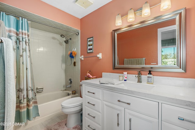 full bathroom with shower / tub combo with curtain, vanity, and toilet