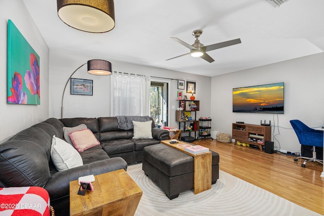 living room with hardwood / wood-style flooring and ceiling fan