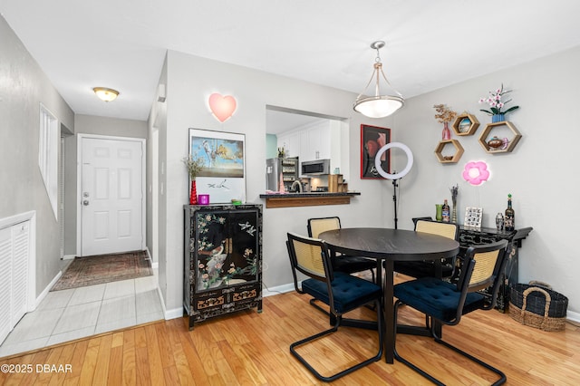 dining space with light wood-type flooring