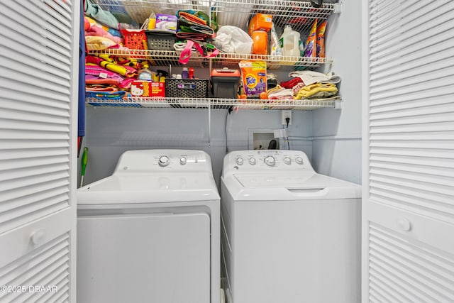 clothes washing area featuring washer and clothes dryer