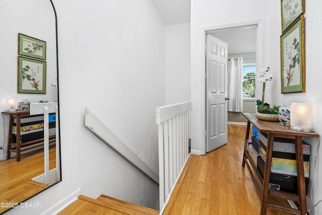 corridor with light hardwood / wood-style floors