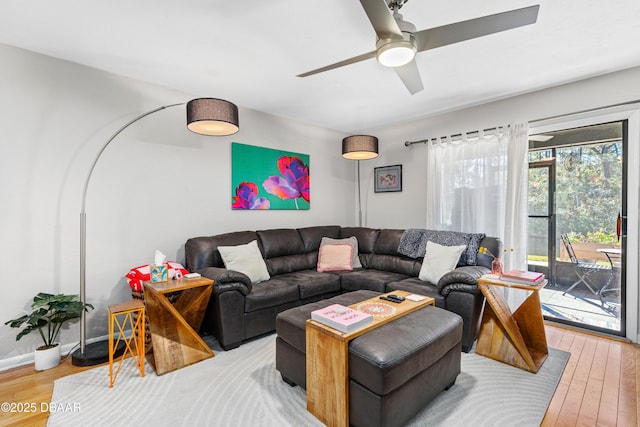 living room featuring hardwood / wood-style floors and ceiling fan