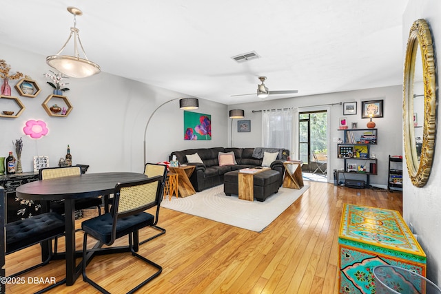 living room with hardwood / wood-style flooring and ceiling fan