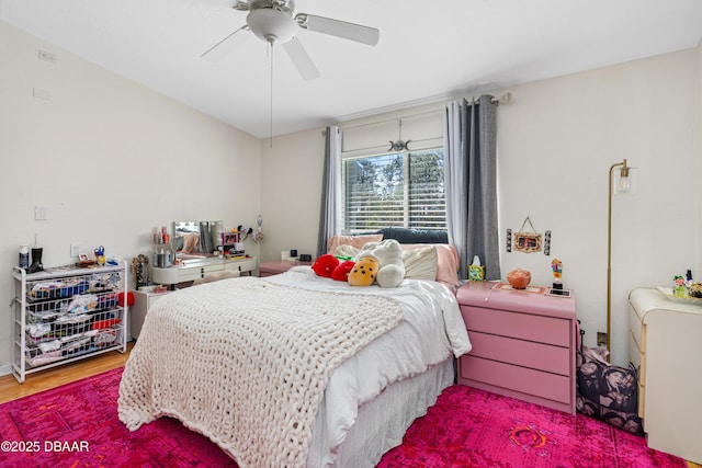 bedroom with ceiling fan and hardwood / wood-style floors