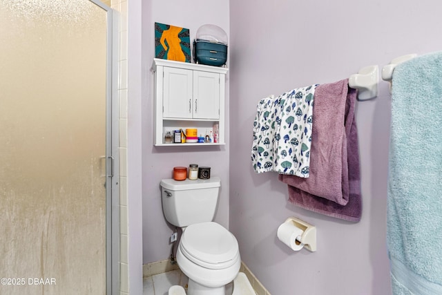 bathroom with a shower with shower door and toilet