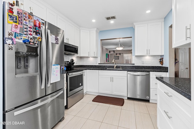 kitchen featuring appliances with stainless steel finishes, sink, and white cabinets