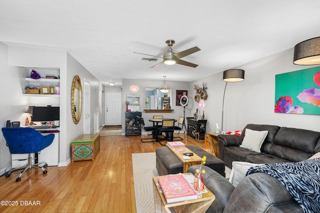 living room with hardwood / wood-style floors and ceiling fan