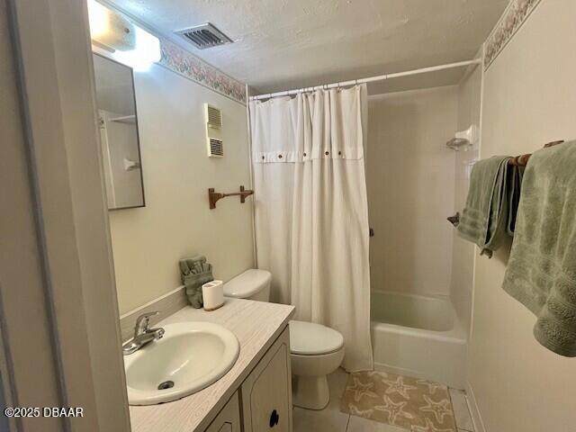 3800 S Atlantic Ave Unit 502, Daytona Beach, FL 32118 - bathroom featuring tile patterned floors, toilet, vanity, and shower / bath combo