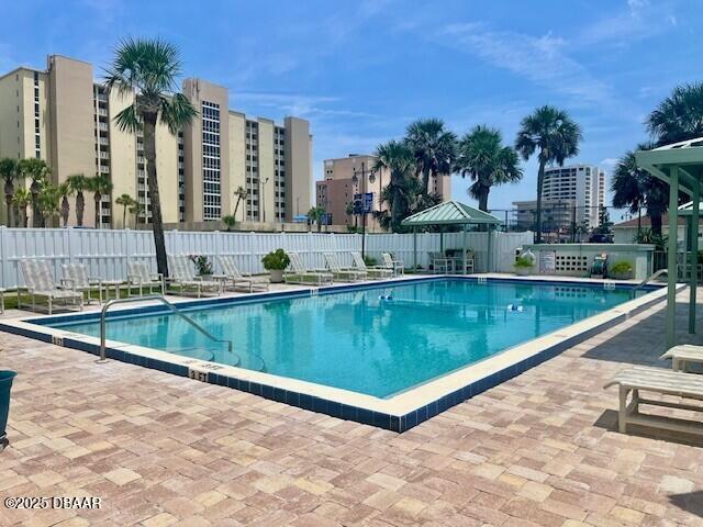 3800 S Atlantic Ave Unit 502, Daytona Beach, FL 32118 - community pool featuring a patio area