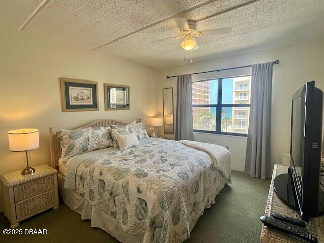 3800 S Atlantic Ave Unit 502, Daytona Beach, FL 32118 - bedroom featuring carpet floors, a textured ceiling, and ceiling fan