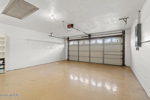 garage featuring a garage door opener and electric panel