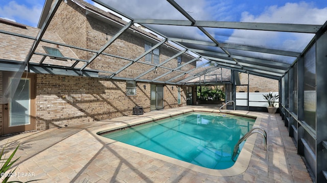 view of swimming pool featuring a patio area and a lanai