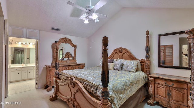 carpeted bedroom featuring connected bathroom, vaulted ceiling, and ceiling fan