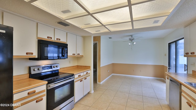 kitchen featuring white cabinetry, light tile patterned flooring, black appliances, and a textured ceiling