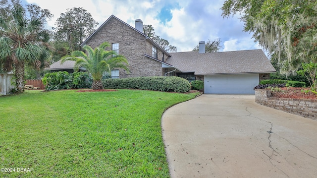 view of front of property featuring a front yard and a garage