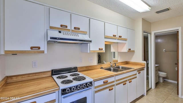 kitchen with white cabinetry, sink, light tile patterned floors, a textured ceiling, and white range with electric cooktop