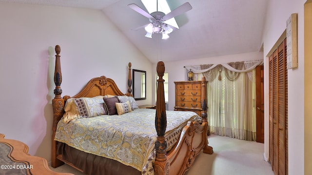 carpeted bedroom with a closet, ceiling fan, and lofted ceiling