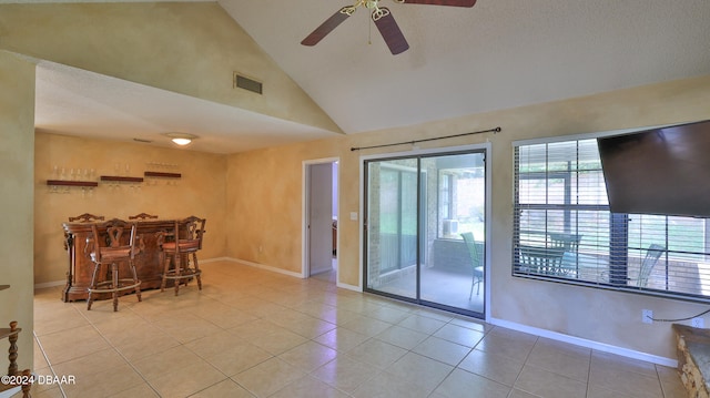 interior space featuring high vaulted ceiling, bar, and ceiling fan