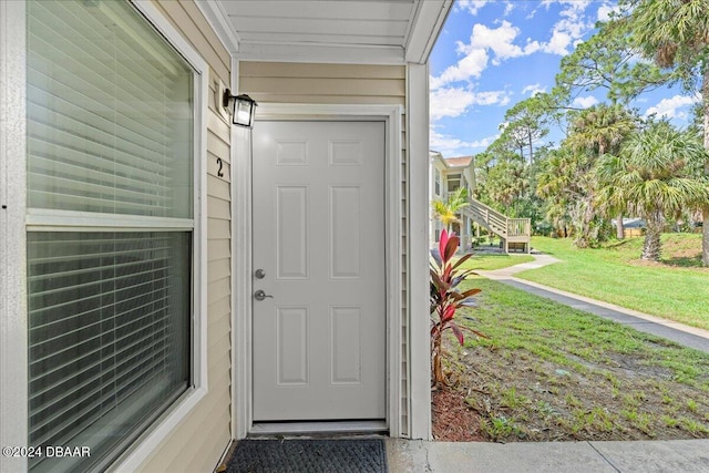 doorway to property featuring a yard