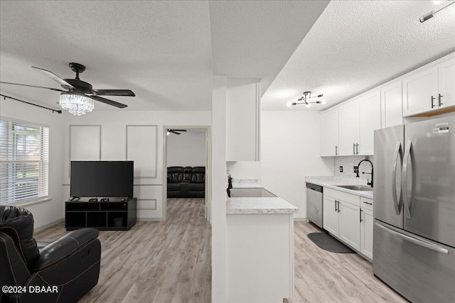 kitchen featuring light hardwood / wood-style floors, white cabinetry, and appliances with stainless steel finishes