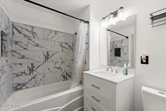 full bathroom featuring toilet, shower / bath combo, vanity, and a textured ceiling