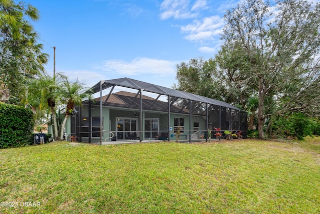 back of house with a yard and glass enclosure