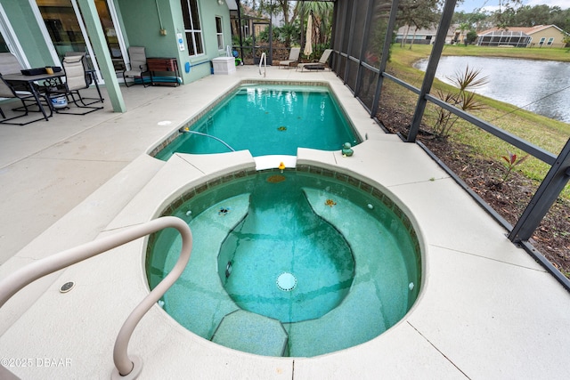 view of pool featuring a water view, a patio area, a pool with connected hot tub, and glass enclosure