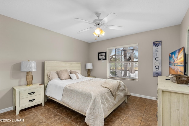 tiled bedroom featuring ceiling fan