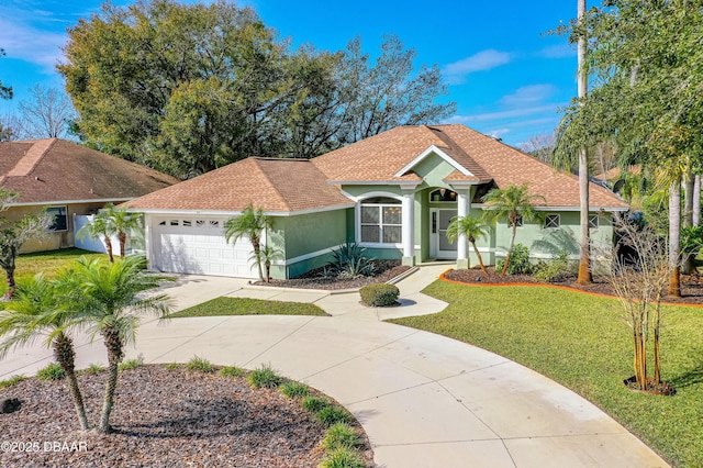 view of front of house with driveway, a shingled roof, an attached garage, a front lawn, and stucco siding