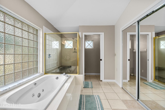 bathroom with baseboards, a tub with jets, tile patterned floors, vaulted ceiling, and a shower stall