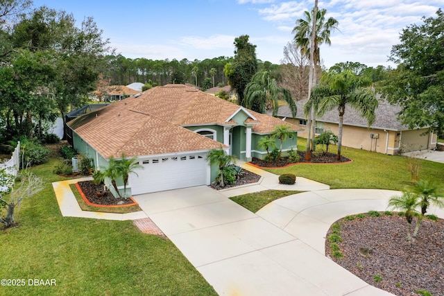 mediterranean / spanish-style house with a garage and a front yard