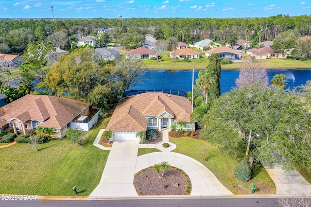 drone / aerial view featuring a water view and a residential view